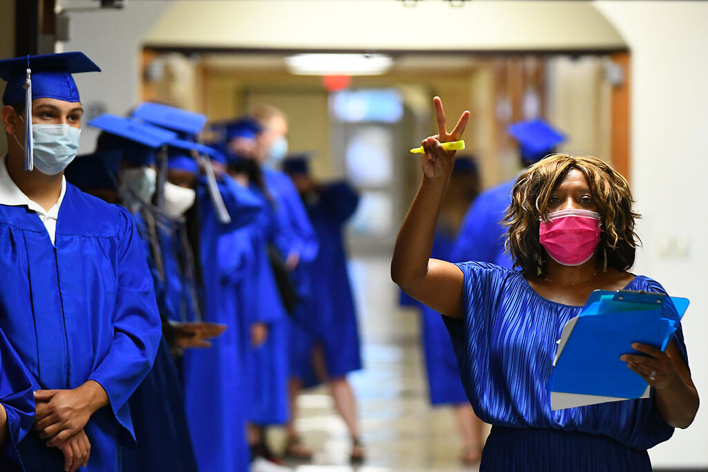 Symone Langston, director of counselor, names graduates to stand in a line